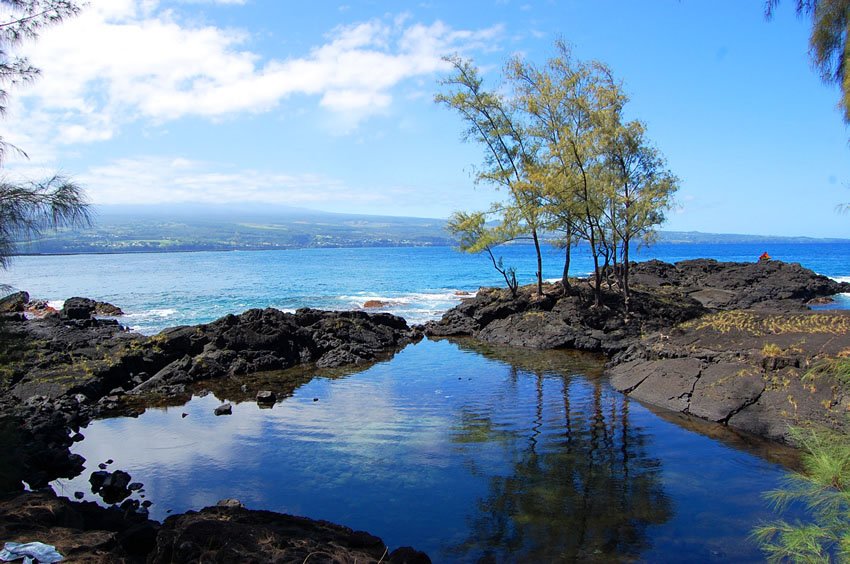 Natural pool surrounded by lava rocks